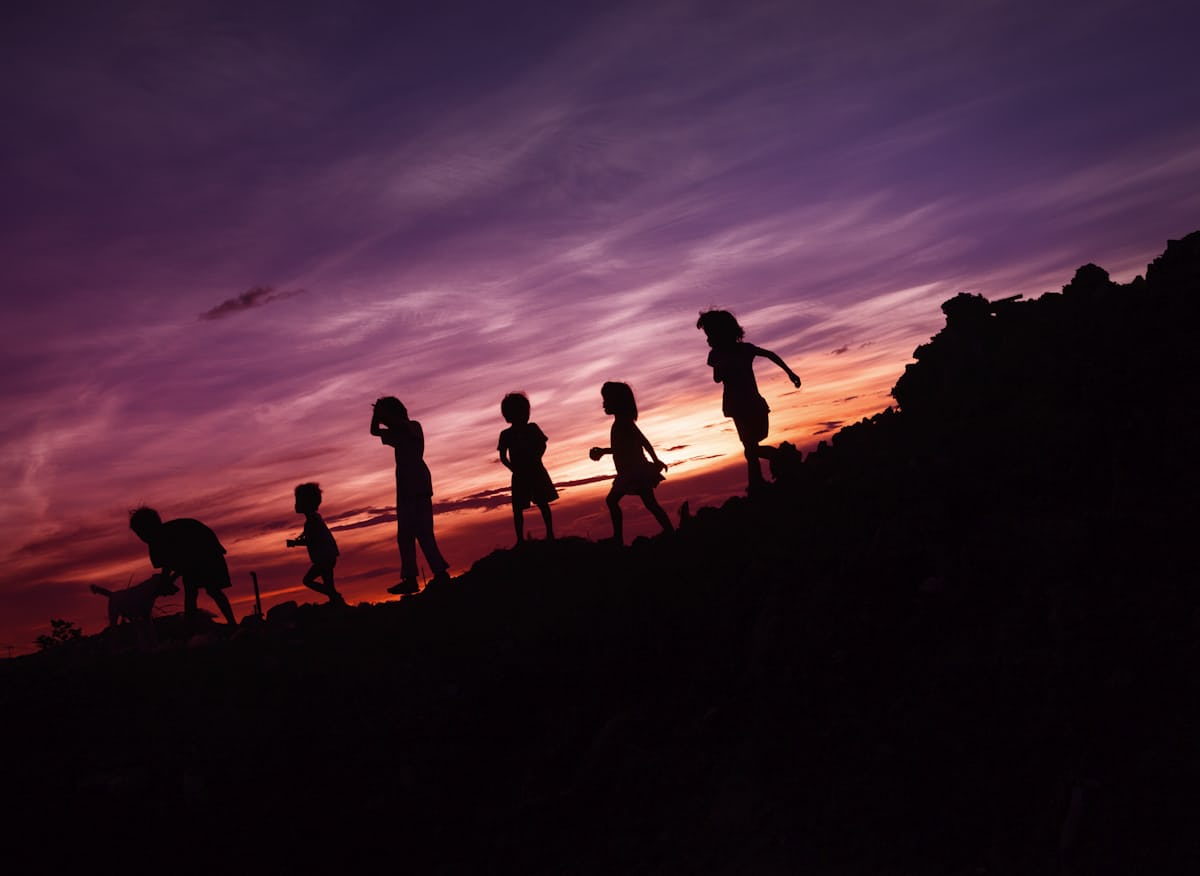 children walking at dusk