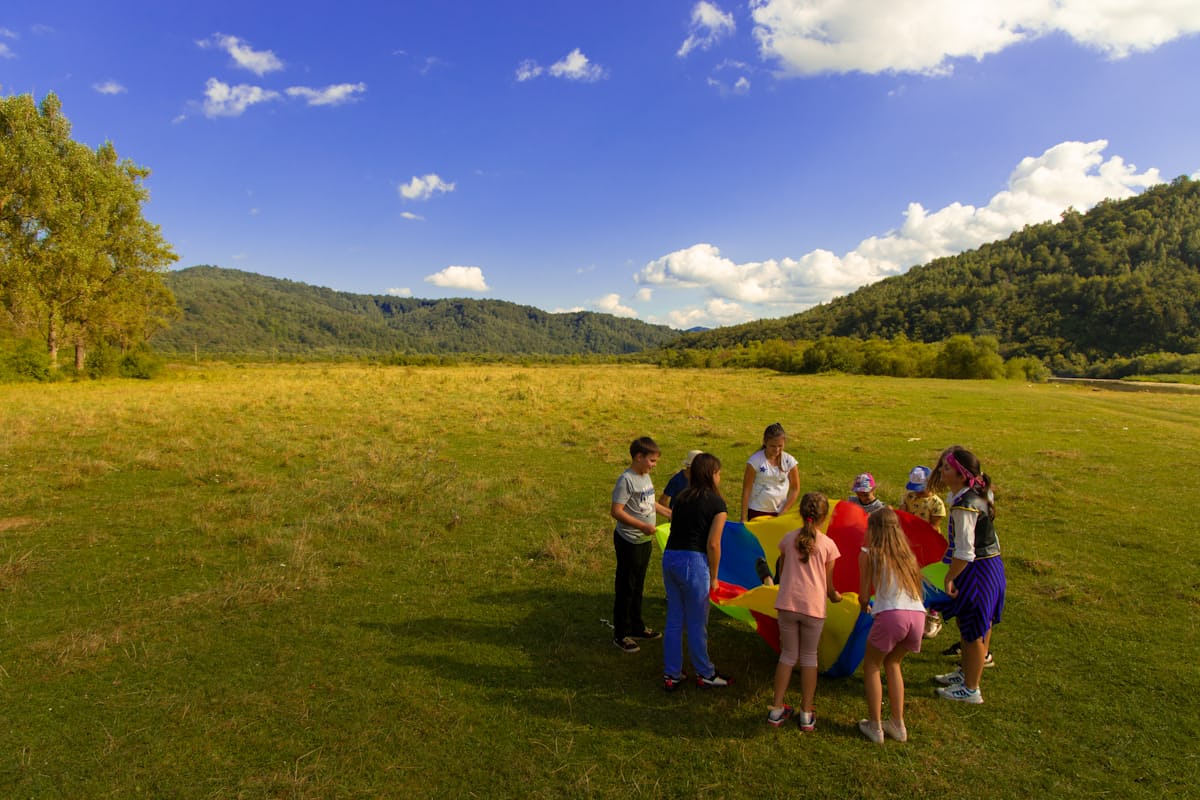 children outside with parachute